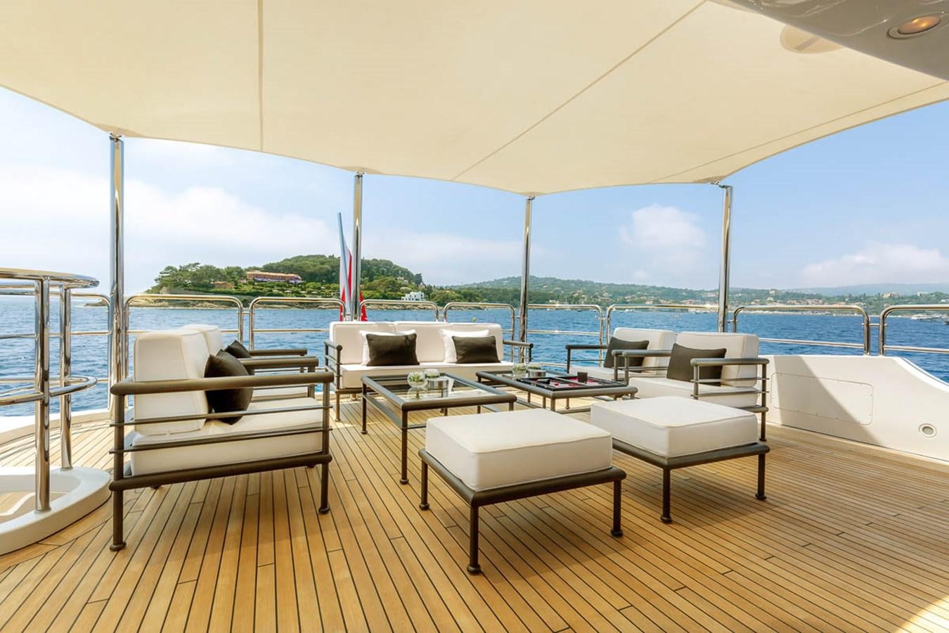 a room with a table chairs and a view of the water aboard MINA Yacht for Sale