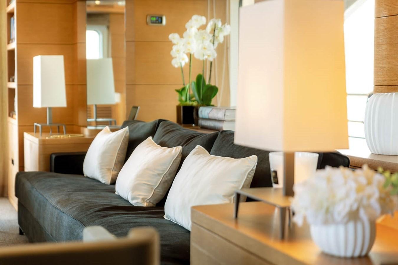 a living room with a couch and a table aboard MINA Yacht for Sale