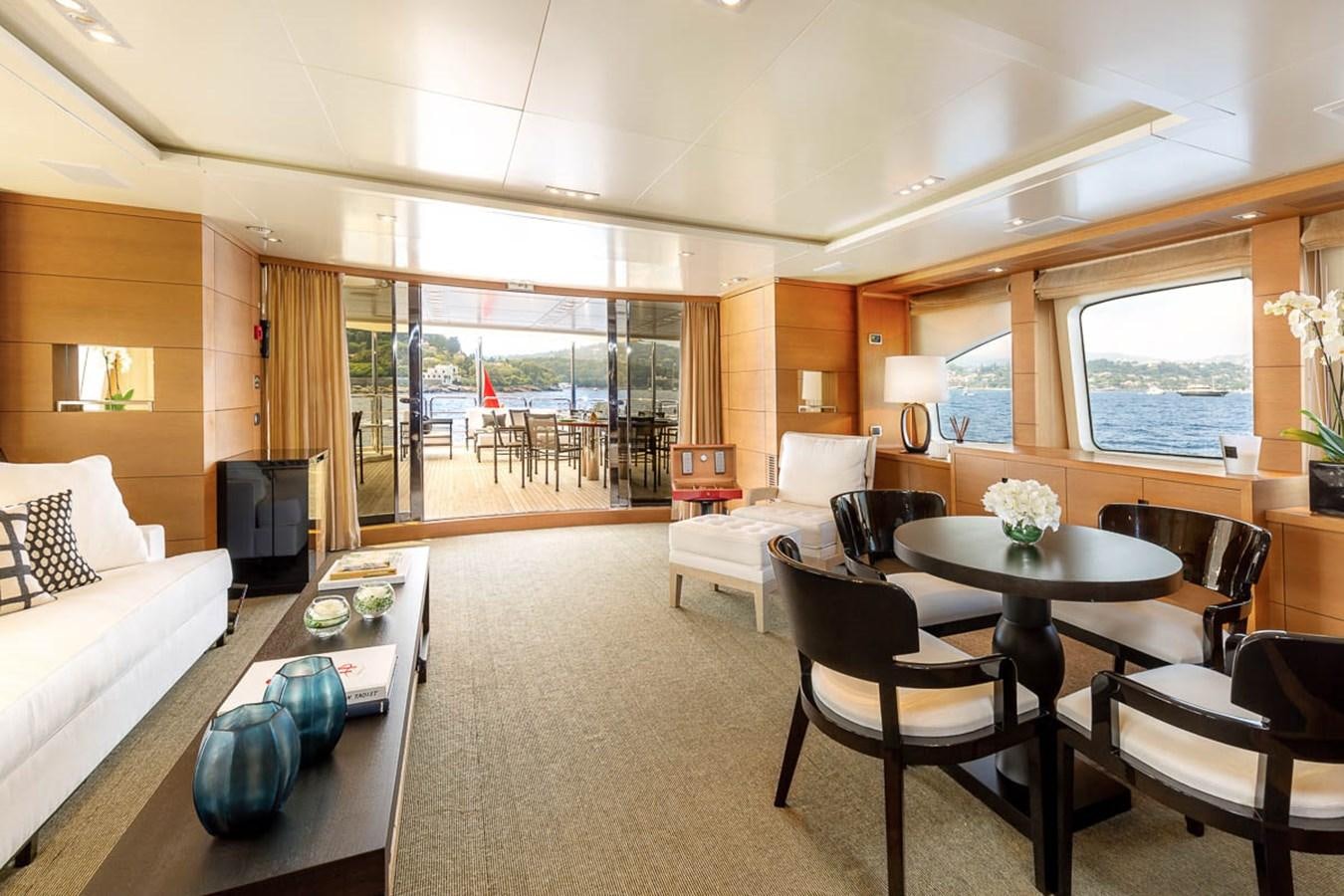a living room with a dining table and chairs aboard MINA Yacht for Sale