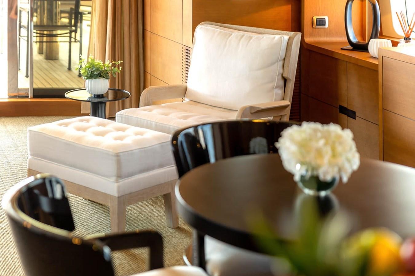 a white chair next to a table aboard MINA Yacht for Sale