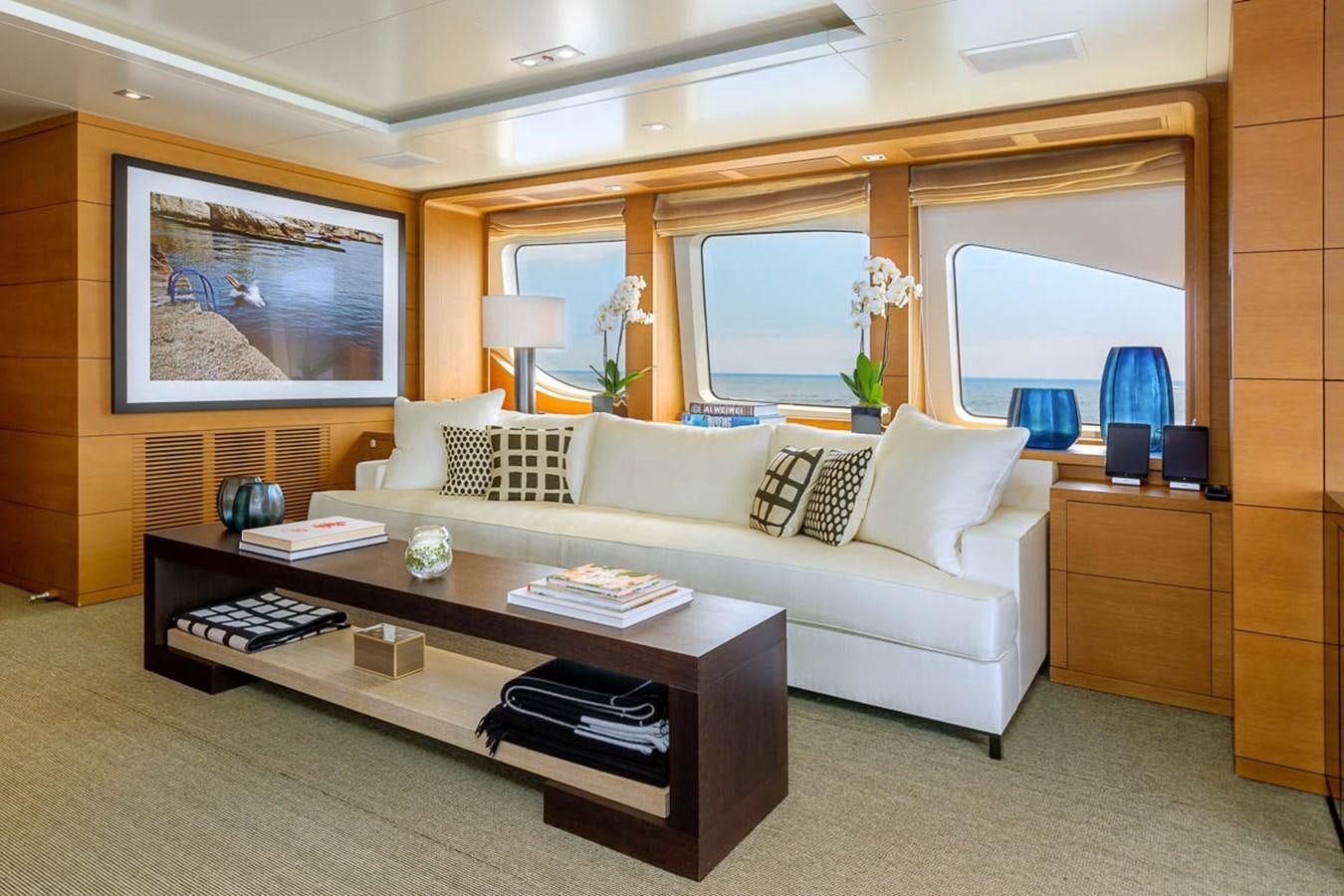 a living room with a white couch aboard MINA Yacht for Sale