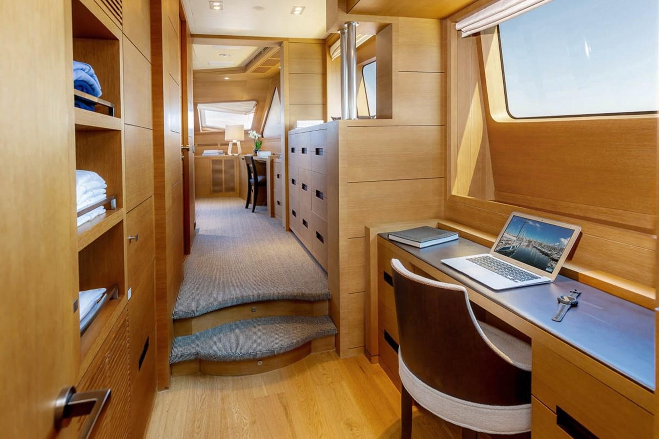 a laptop on a desk aboard MINA Yacht for Sale