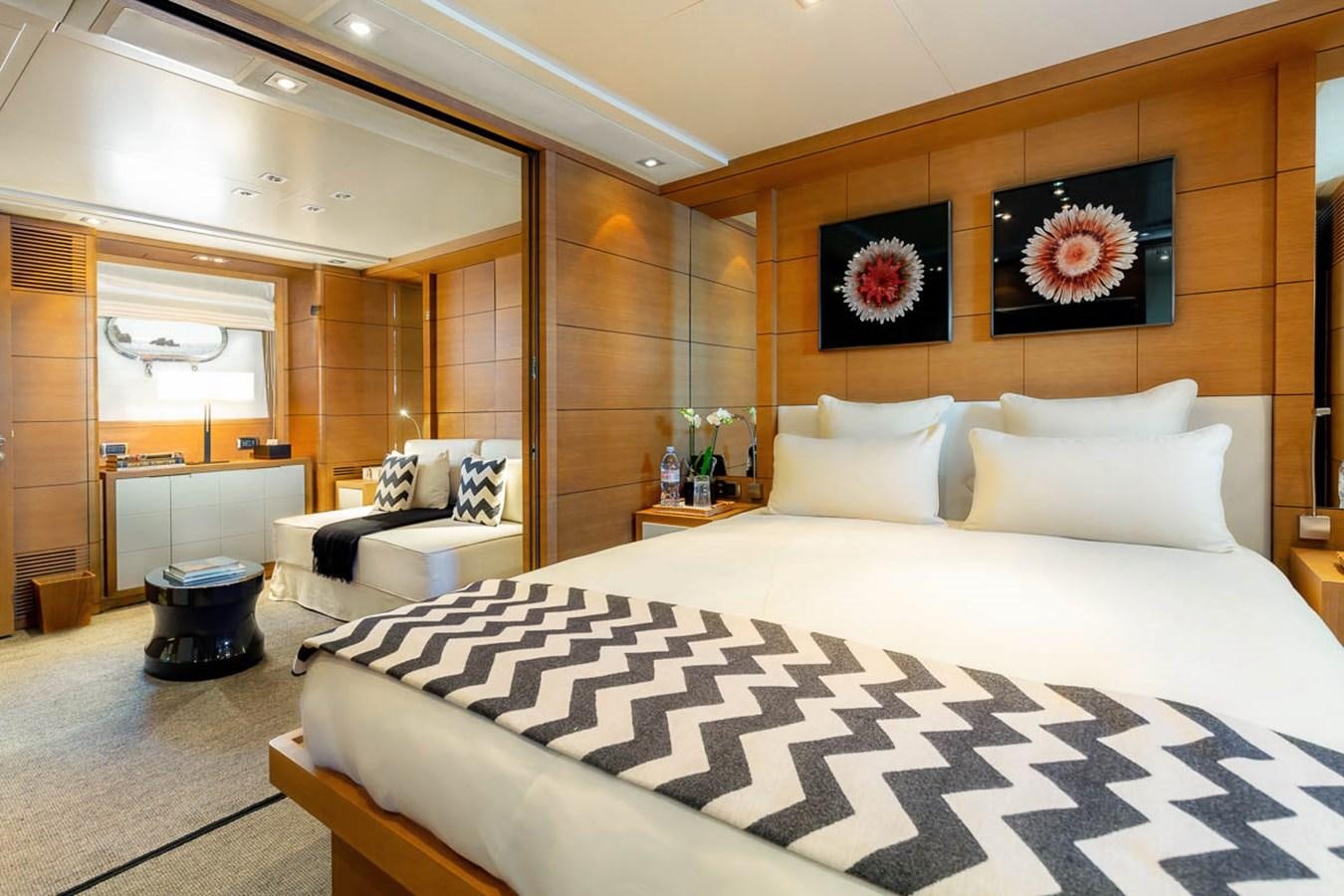 a bedroom with a bed and a couch aboard MINA Yacht for Sale