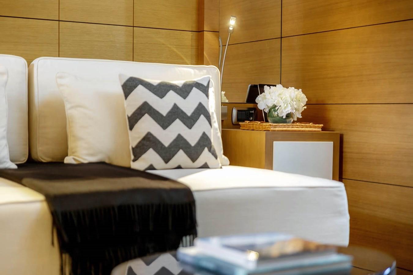 a room with a bed and a chair aboard MINA Yacht for Sale