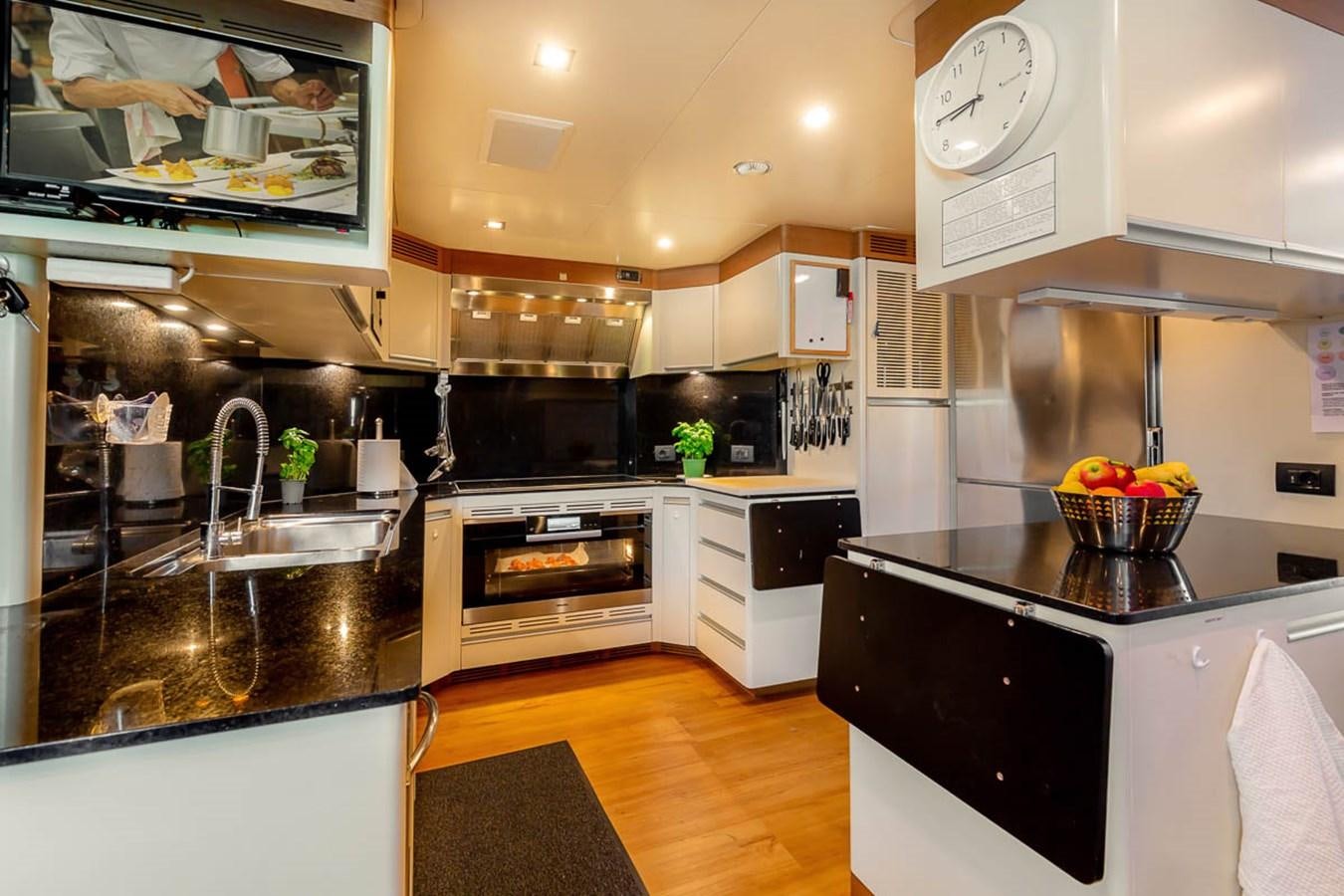 a kitchen with a stove and oven aboard MINA Yacht for Sale