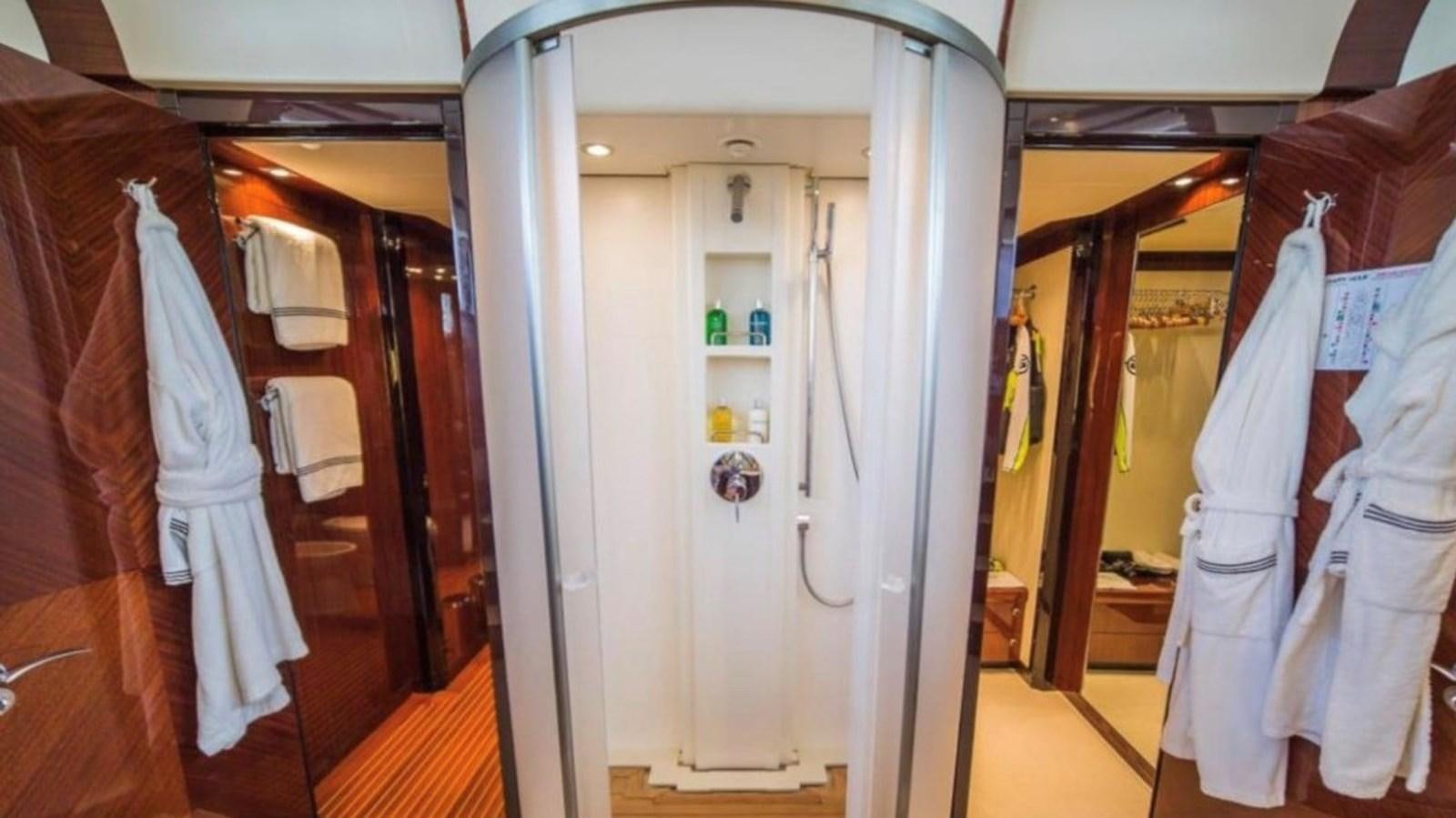 a closet with clothes on the wall aboard MY HAPPY HOUR Yacht for Sale