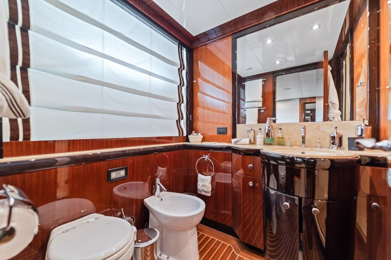 a bathroom with a large mirror aboard MY HAPPY HOUR Yacht for Sale