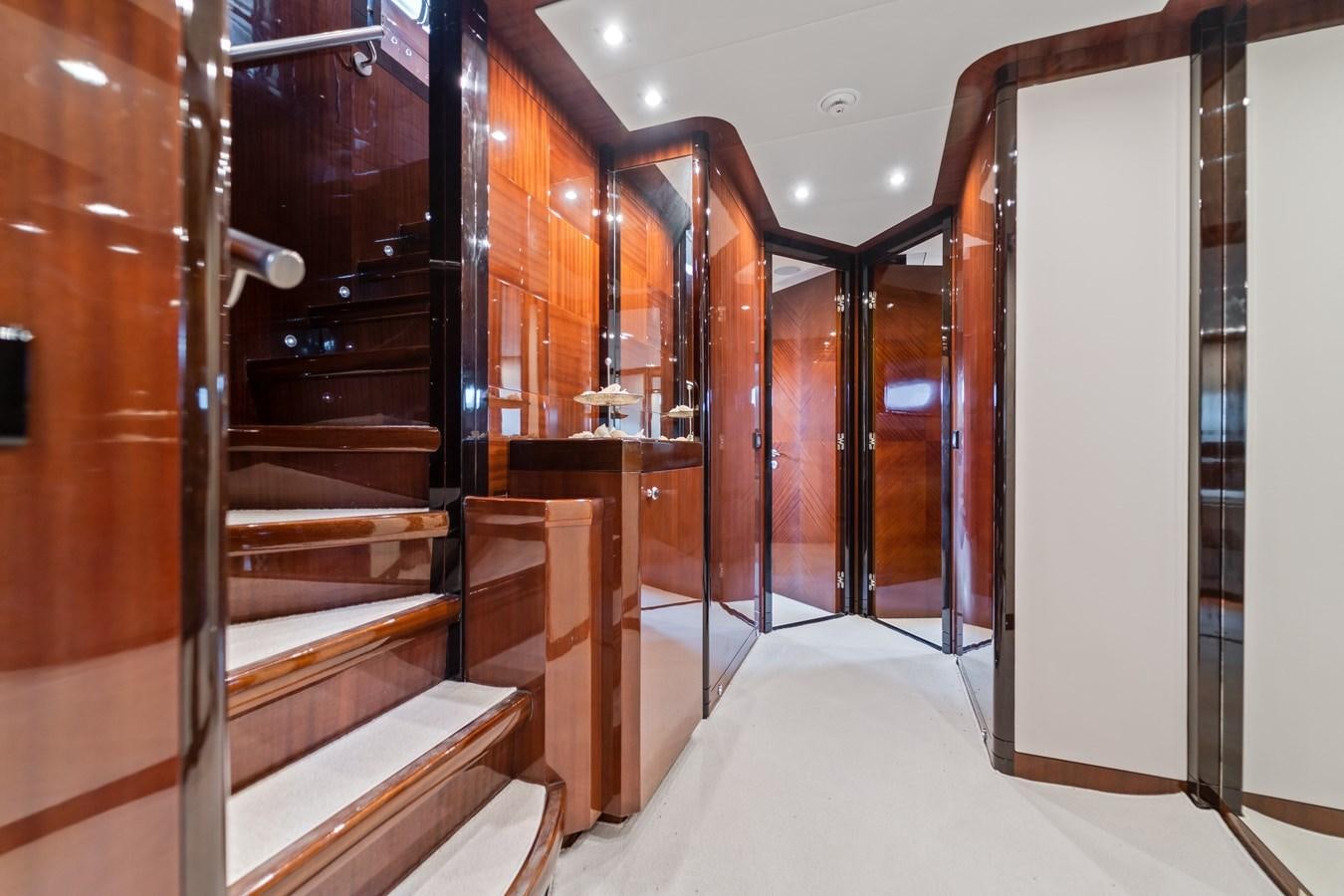 a room with a set of wooden stairs and a white wall aboard MY HAPPY HOUR Yacht for Sale