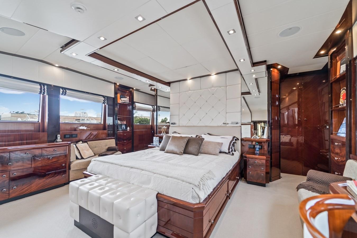 a bedroom with a bed and a large window aboard MY HAPPY HOUR Yacht for Sale