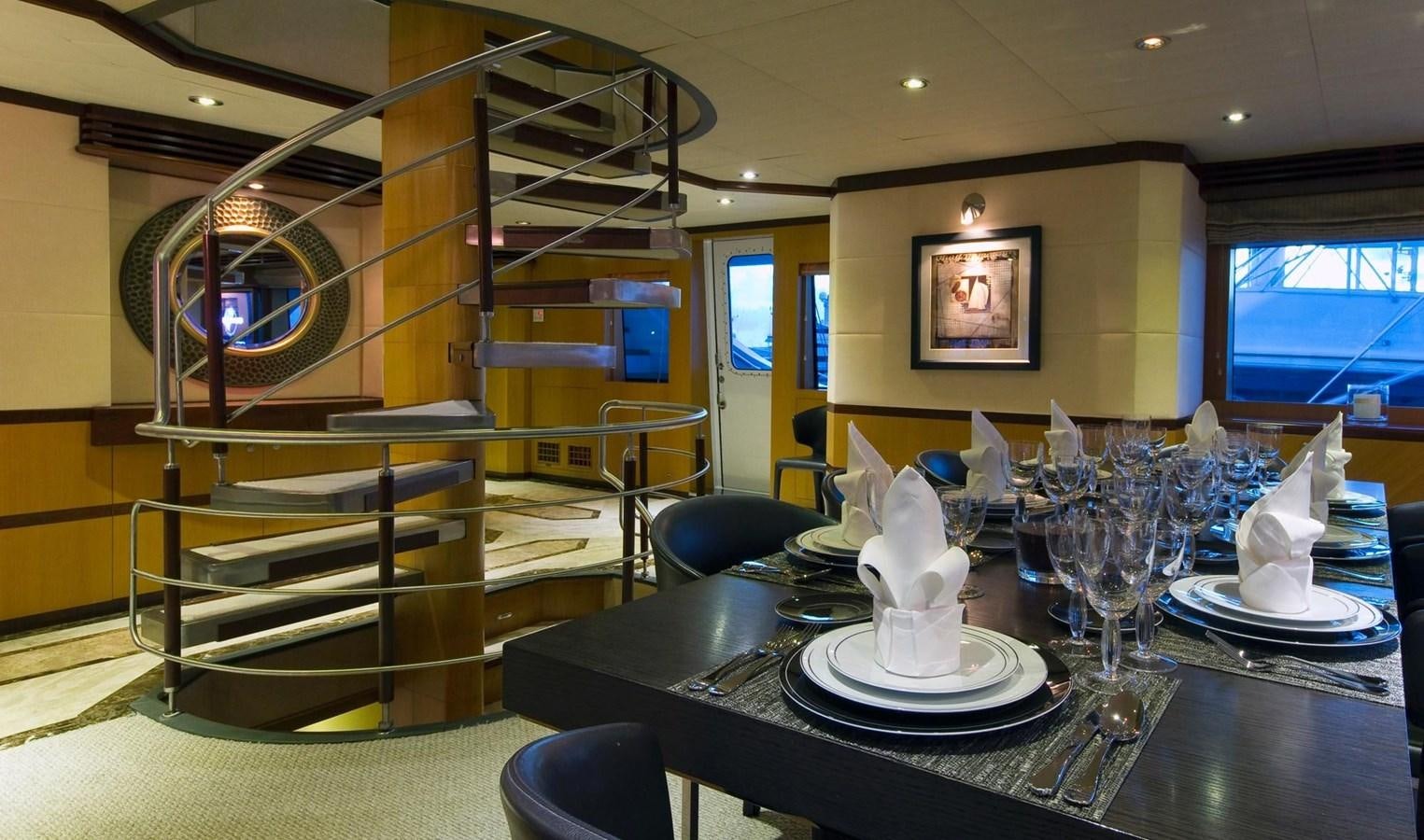 a large room with a table and chairs aboard NO NAME  2002 120 TRI-DECK M/Y Yacht for Sale