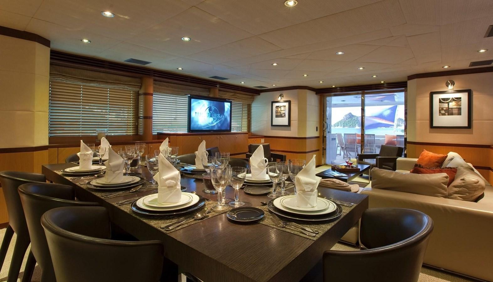 a large dining table with a large window aboard NO NAME  2002 120 TRI-DECK M/Y Yacht for Sale