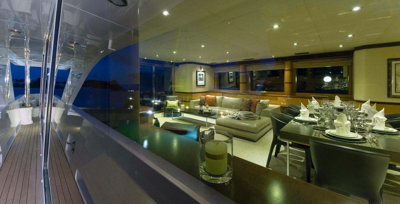 a large room with a table and chairs aboard NO NAME  2002 120 TRI-DECK M/Y Yacht for Sale