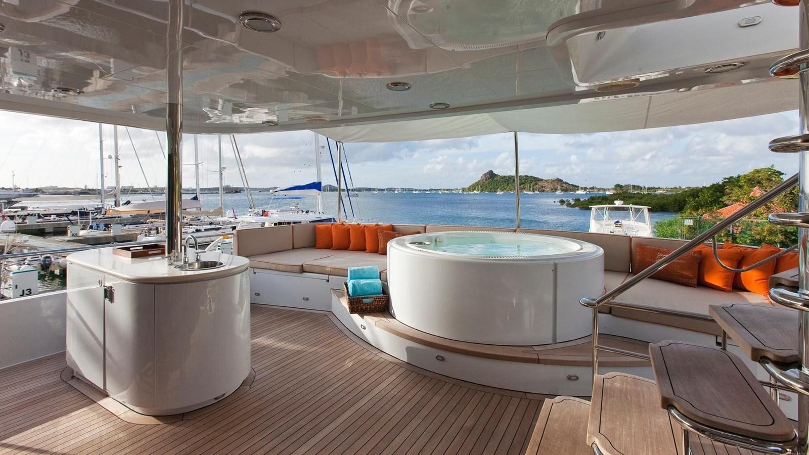 a room with a couch and a table and a large window aboard NO NAME  2002 120 TRI-DECK M/Y Yacht for Sale