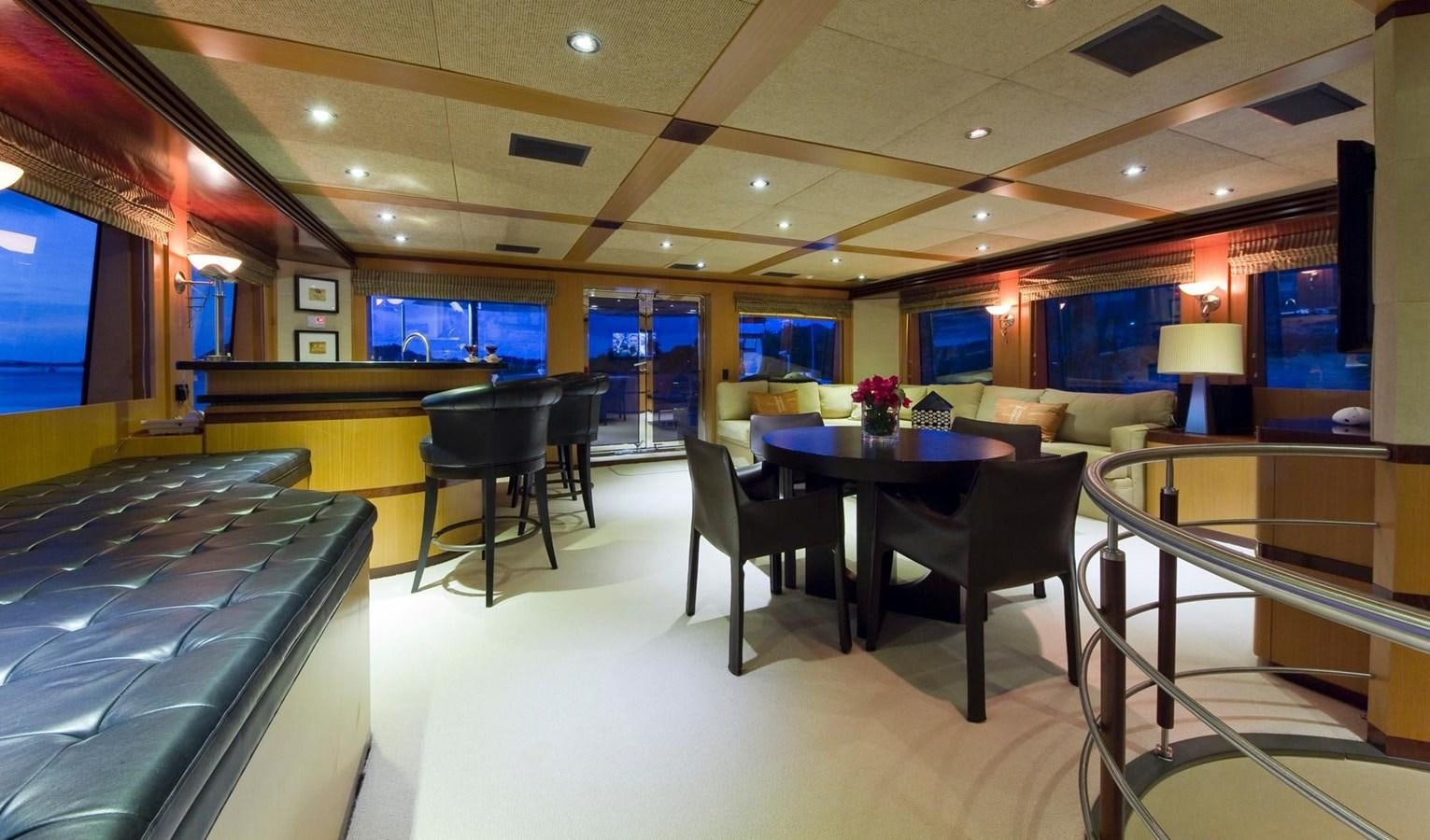 a room with a table and chairs aboard NO NAME  2002 120 TRI-DECK M/Y Yacht for Sale