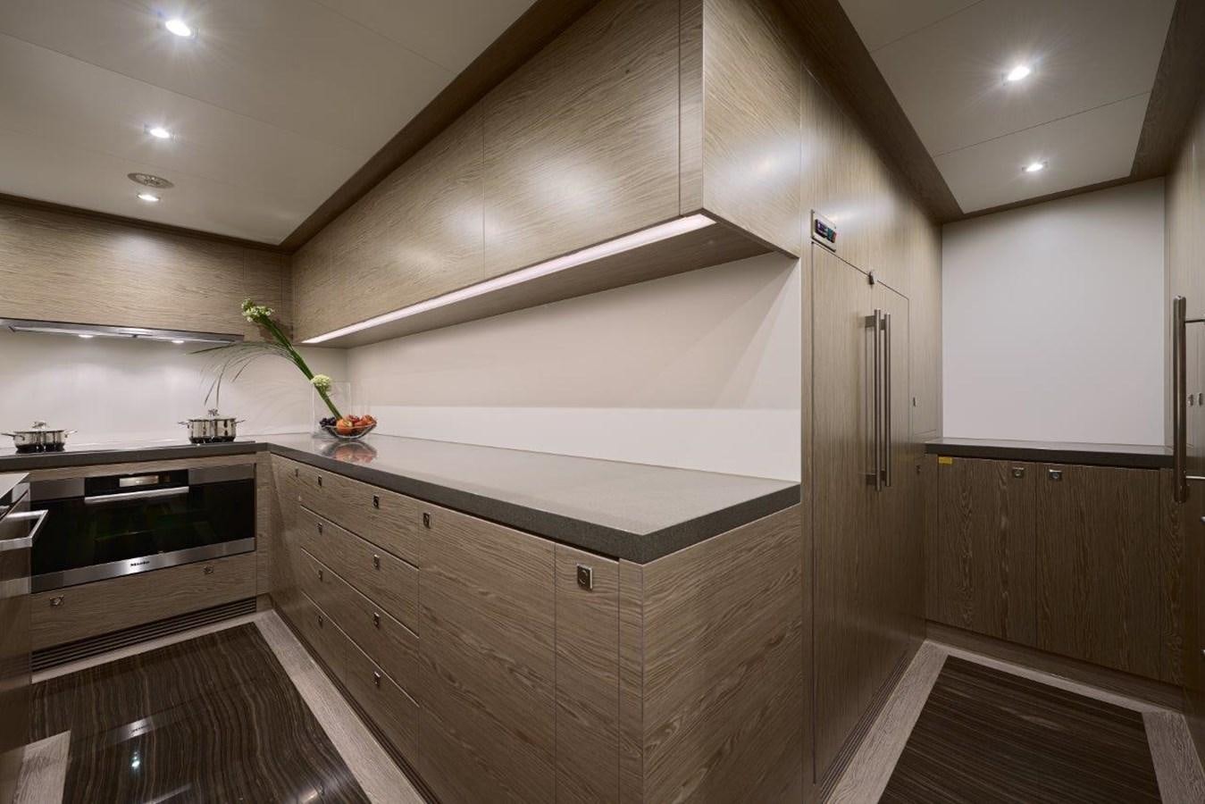 a kitchen with wooden cabinets aboard RP120 (NEW BOAT SPEC) Yacht for Sale
