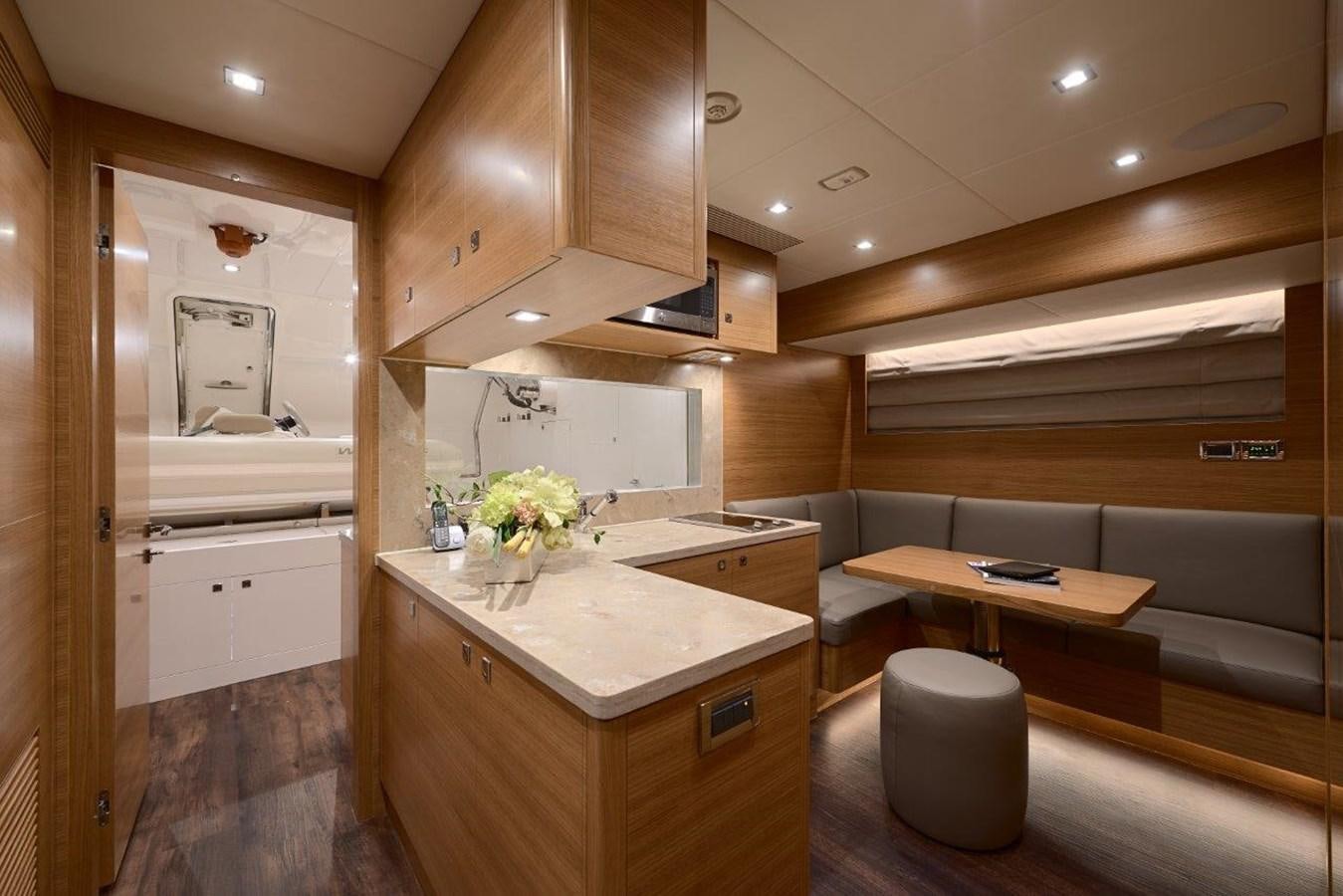 a kitchen with wooden cabinets aboard RP120 (NEW BOAT SPEC) Yacht for Sale