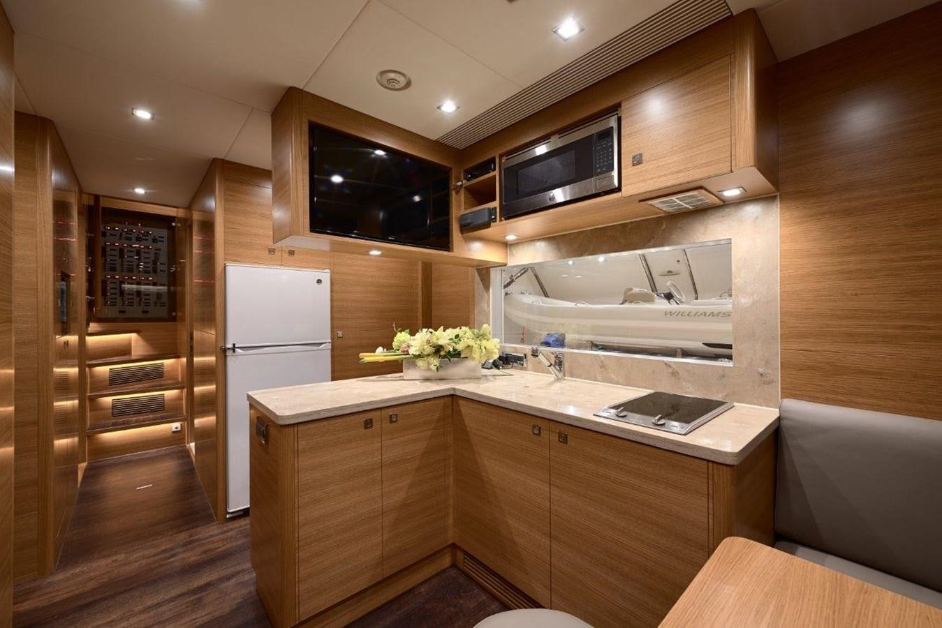a kitchen with wooden cabinets aboard RP120 (NEW BOAT SPEC) Yacht for Sale