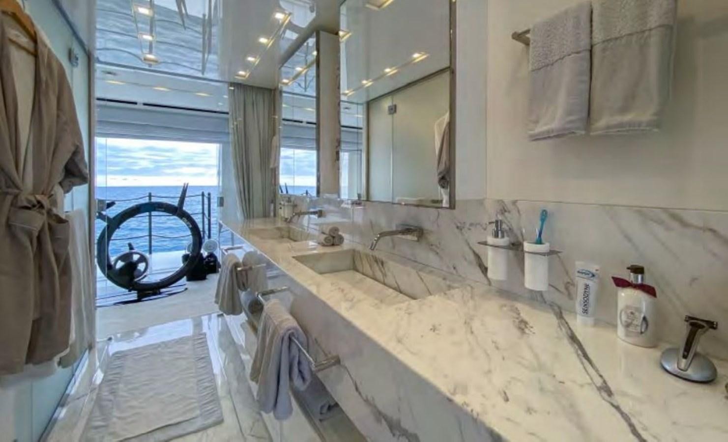 a bathroom with a sink and a washing machine aboard CAIA S Yacht for Sale