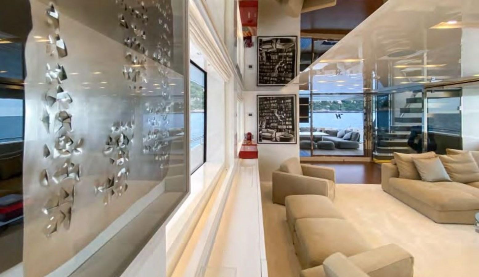 a room with a couch and a table and chairs aboard CAIA S Yacht for Sale