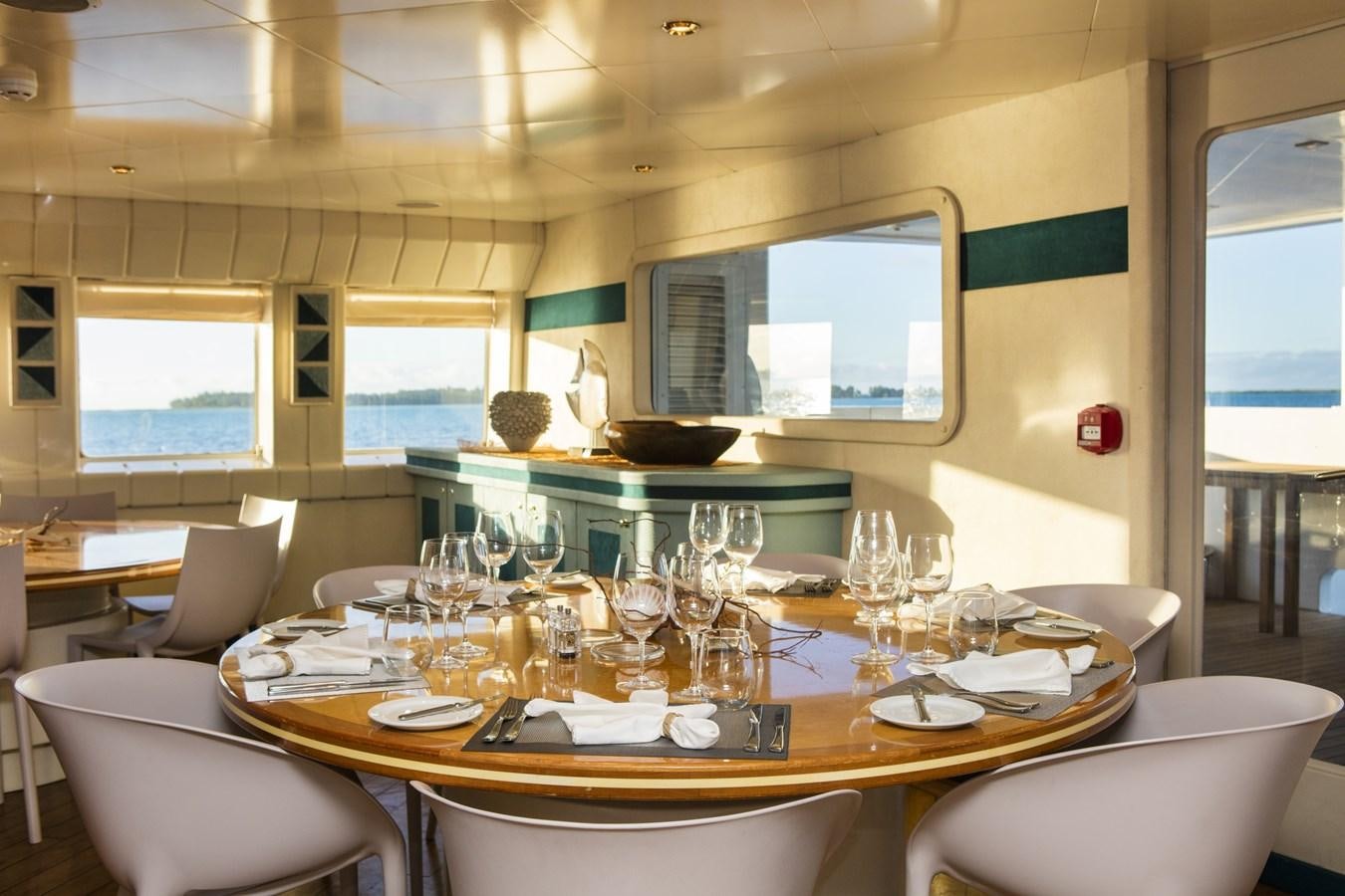 a table with wine glasses aboard HAUMANA Yacht for Sale