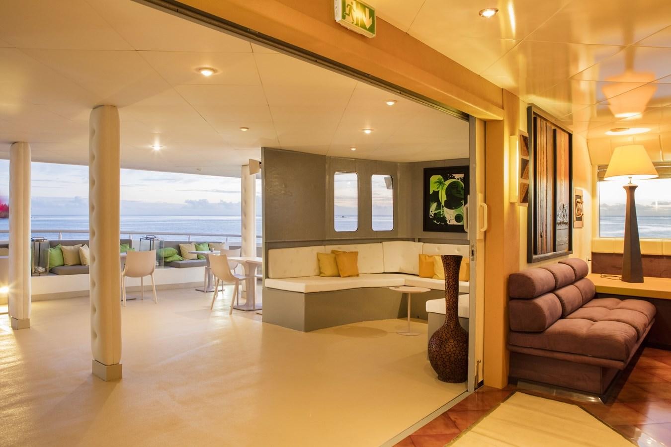 a living room with a large window aboard HAUMANA Yacht for Sale