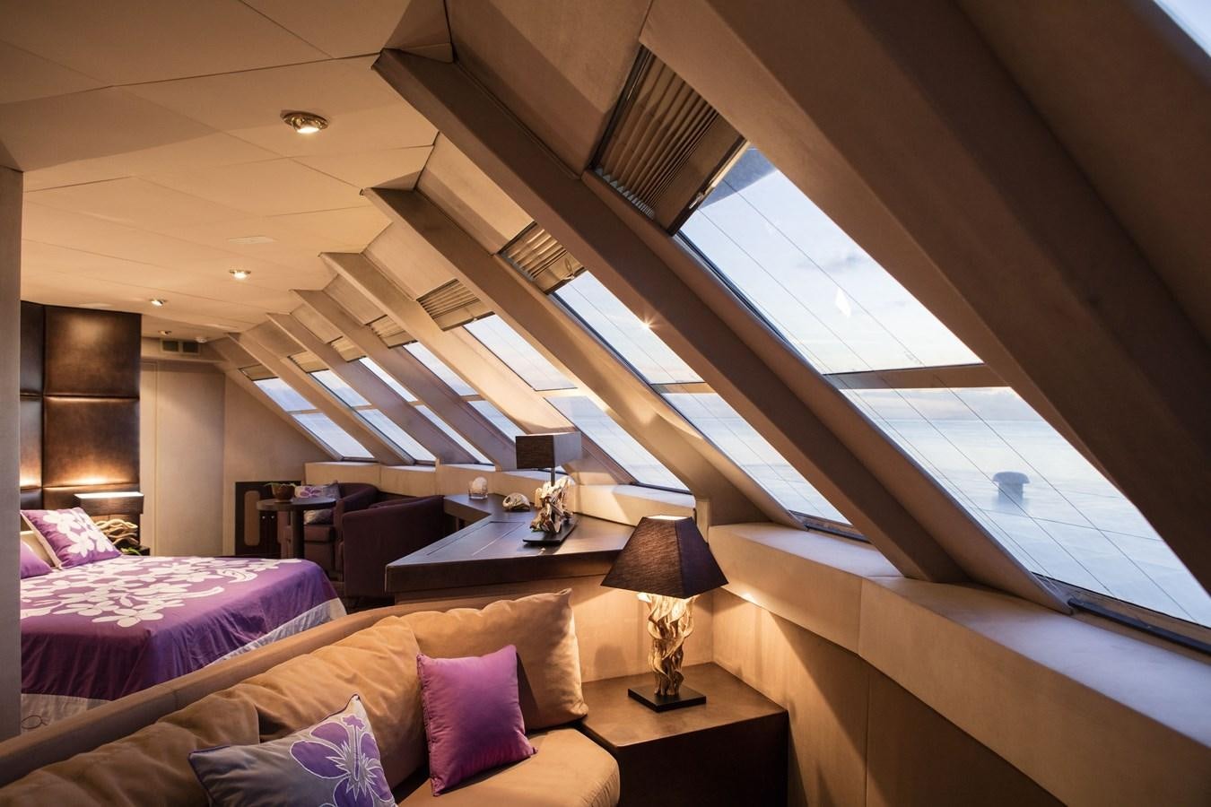 a room with a bed and a lamp aboard HAUMANA Yacht for Sale