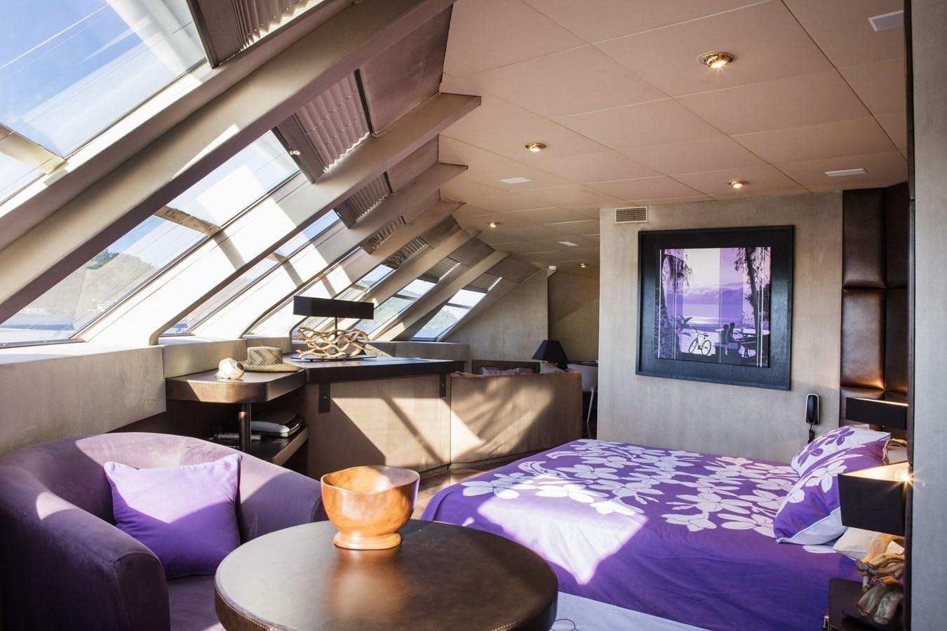 a room with a bed and a television aboard HAUMANA Yacht for Sale