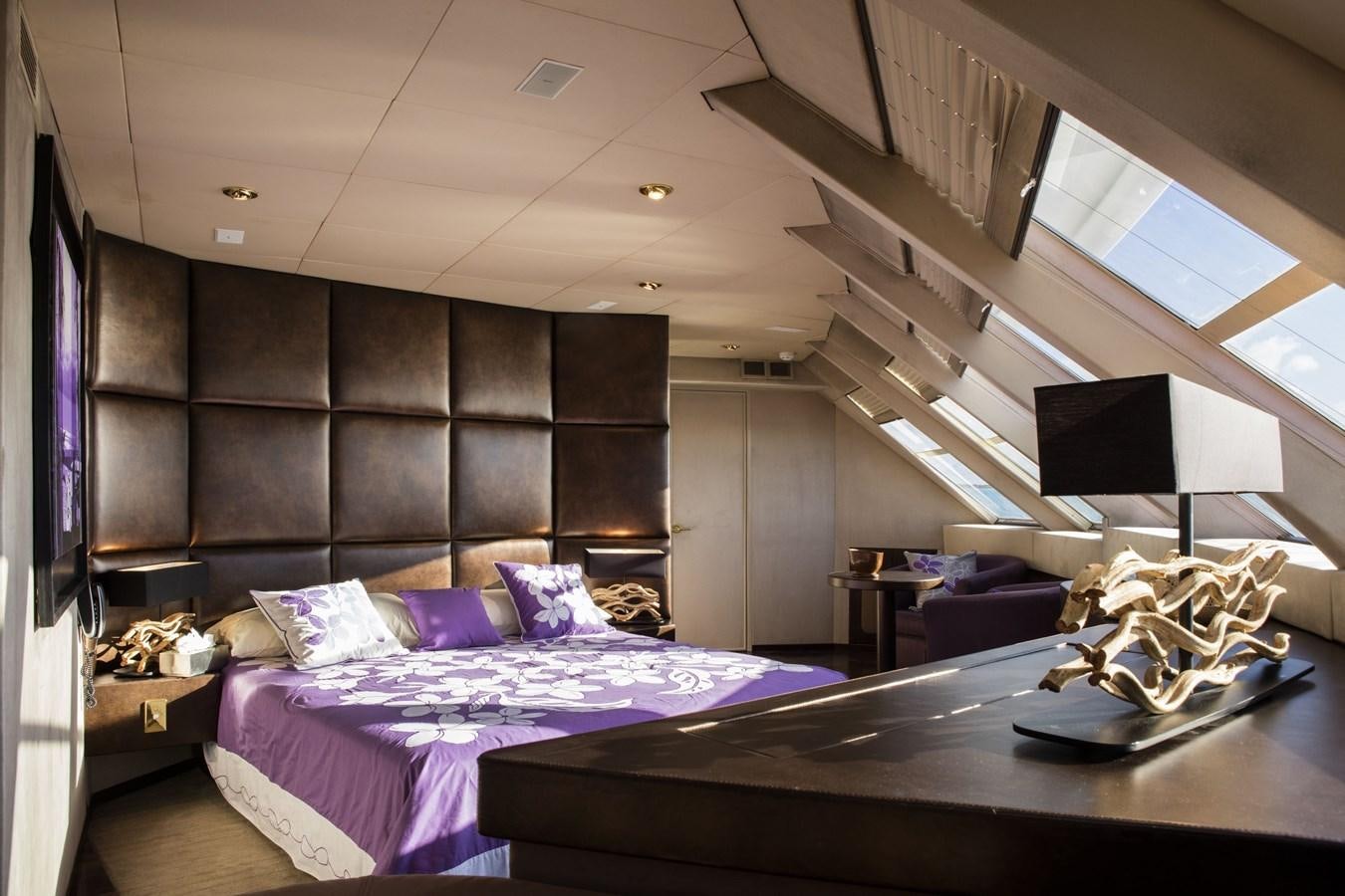 a bedroom with a large bed aboard HAUMANA Yacht for Sale