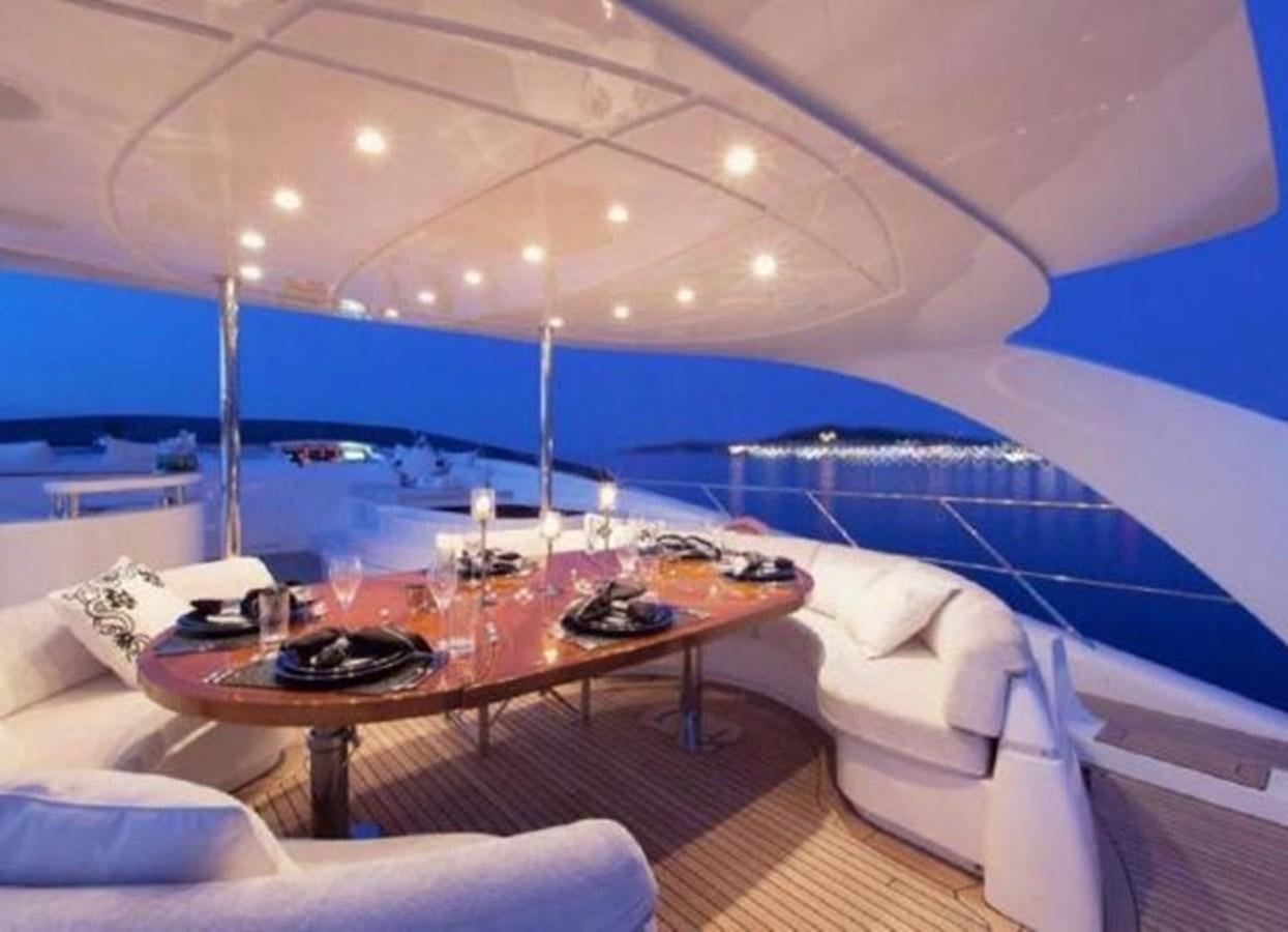 a room with a table and chairs aboard ISA 120 Yacht for Sale