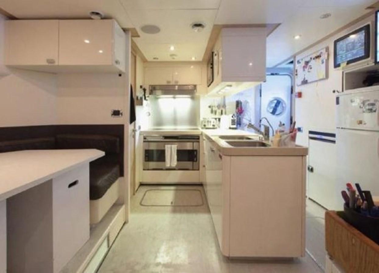 a kitchen with white cabinets aboard ISA 120 Yacht for Sale