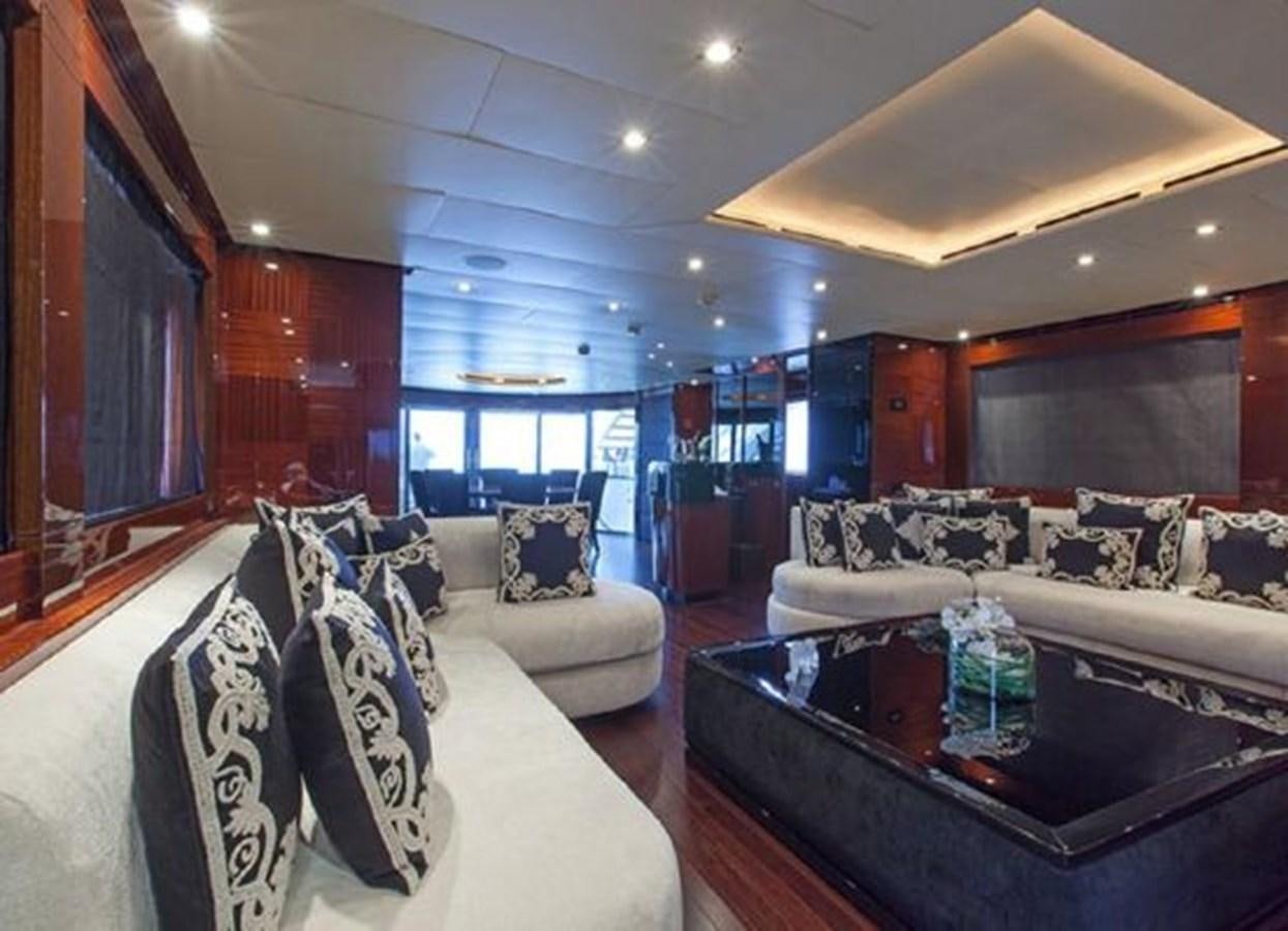 a living room with a couch and a table aboard ISA 120 Yacht for Sale