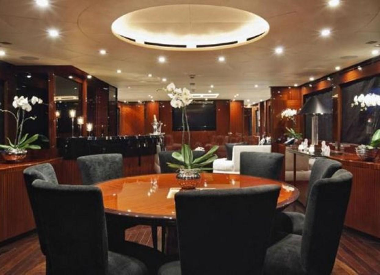 a restaurant with a table and chairs aboard ISA 120 Yacht for Sale
