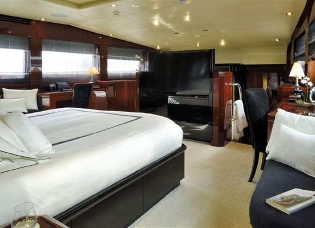 a room with a bed and a tv aboard ISA 120 Yacht for Sale