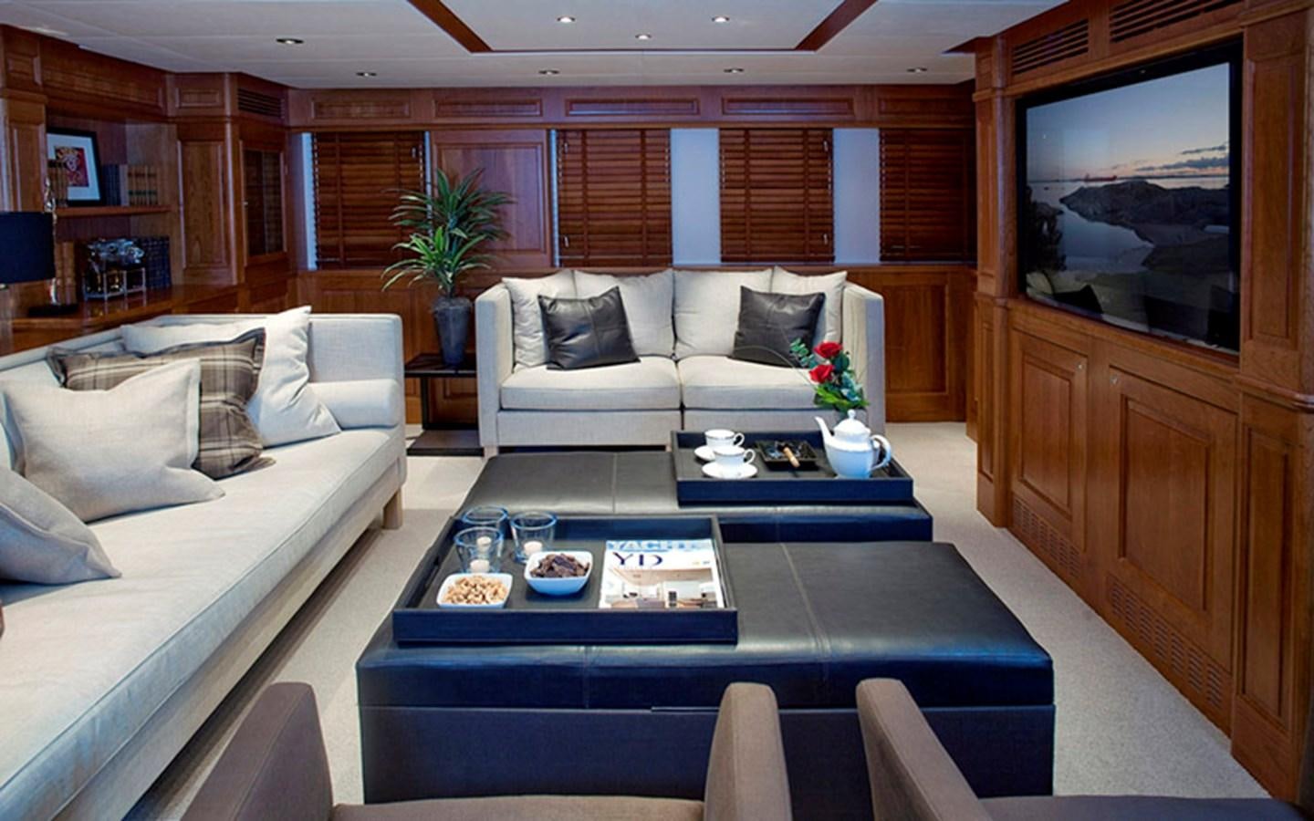 a living room with a blue table and a blue coffee table aboard SUNNY HILL Yacht for Sale