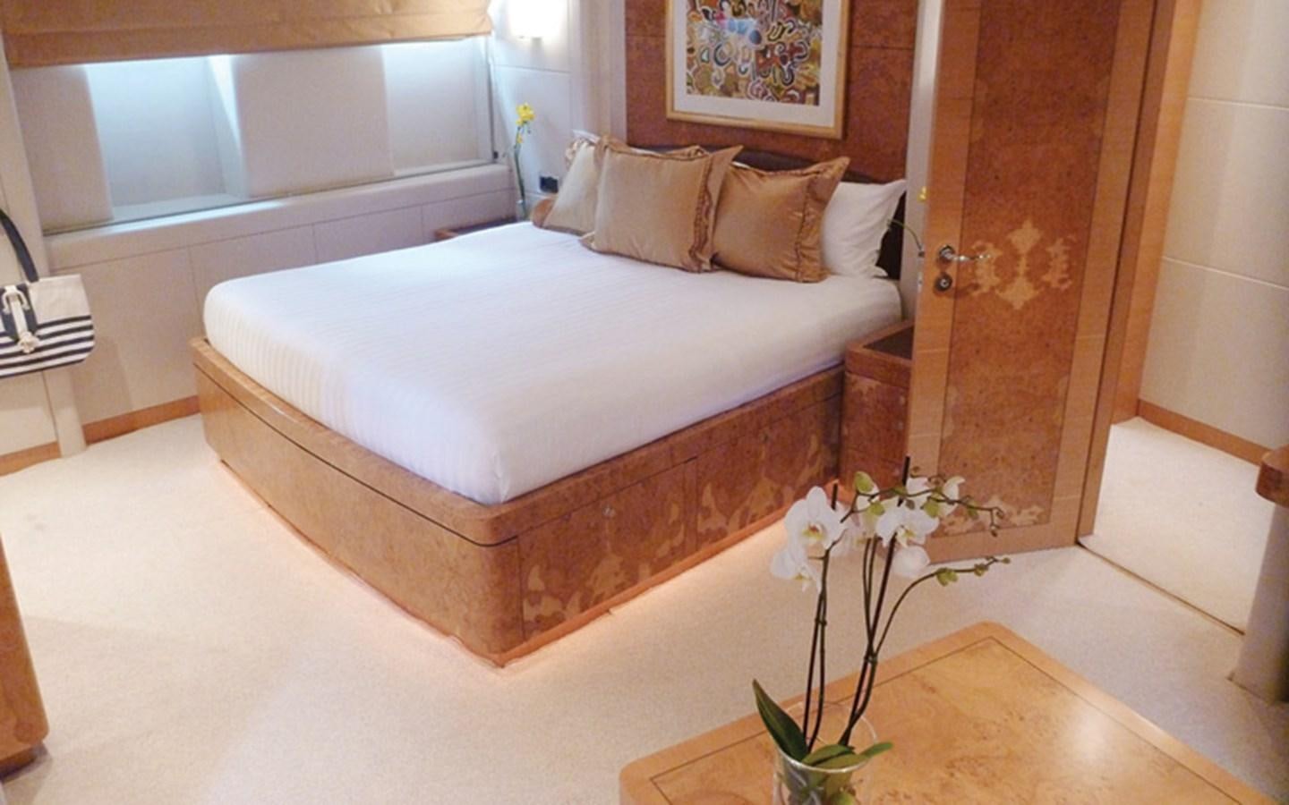 a bed with a white sheet aboard SUNNY HILL Yacht for Sale