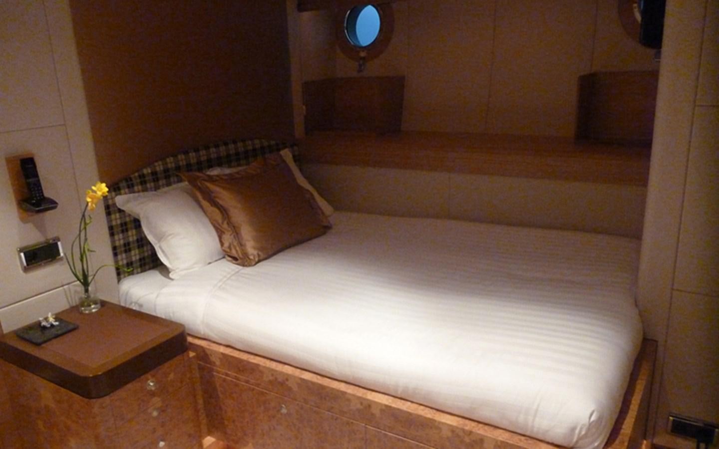 a bed with a white sheet aboard SUNNY HILL Yacht for Sale