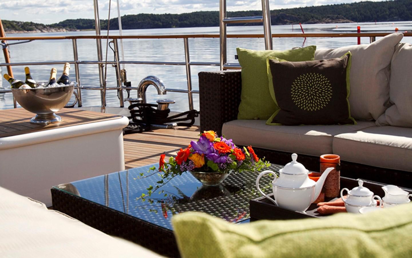 a table with a bowl of flowers on it aboard SUNNY HILL Yacht for Sale