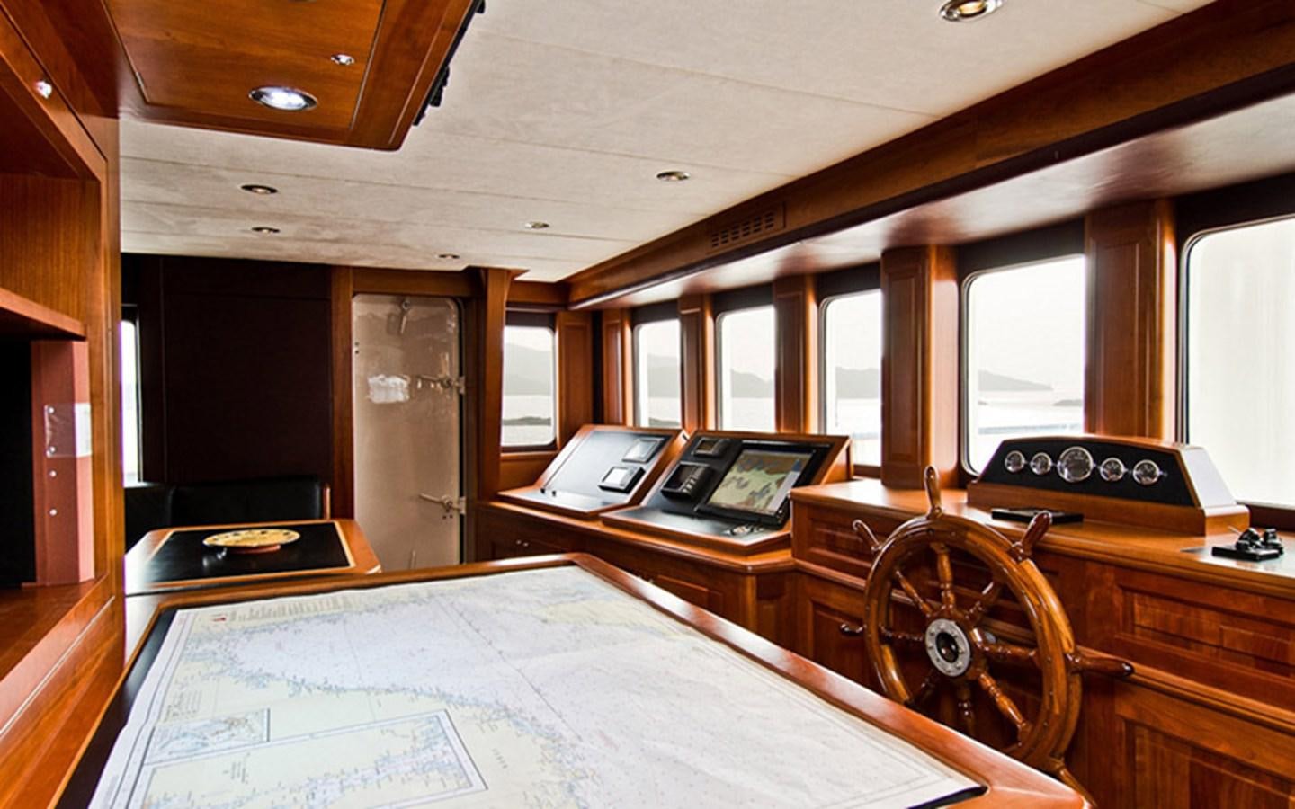 a room with a bed and desk aboard SUNNY HILL Yacht for Sale
