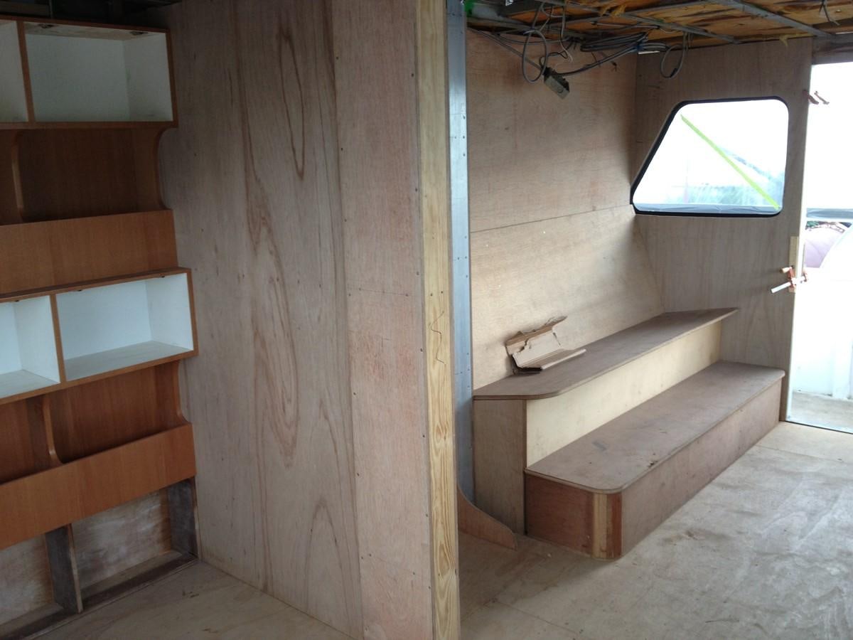 a room with a bench and a window aboard CALLISTO Yacht for Sale