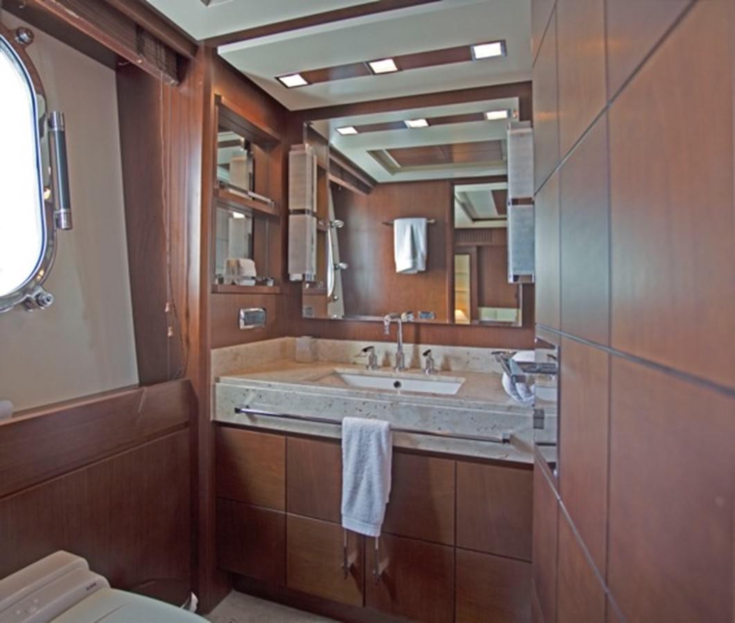 a bathroom with a sink and a mirror aboard MOMENTO.   2006 AZIMUT 116 @ Yacht for Sale