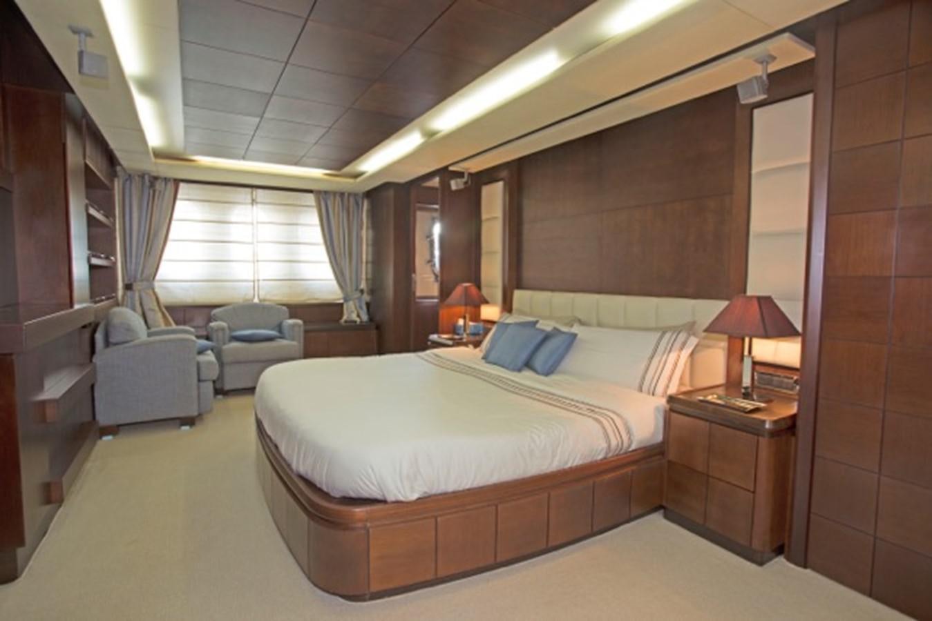 a hotel room with a bed and a chair aboard MOMENTO.   2006 AZIMUT 116 @ Yacht for Sale