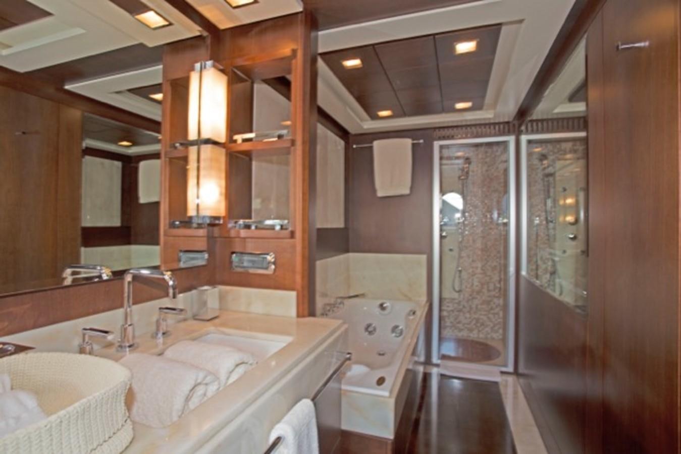 a bathroom with a large mirror aboard MOMENTO.   2006 AZIMUT 116 @ Yacht for Sale