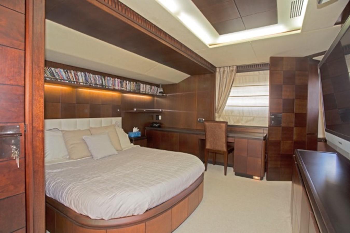 a bedroom with a bed and desk aboard MOMENTO.   2006 AZIMUT 116 @ Yacht for Sale