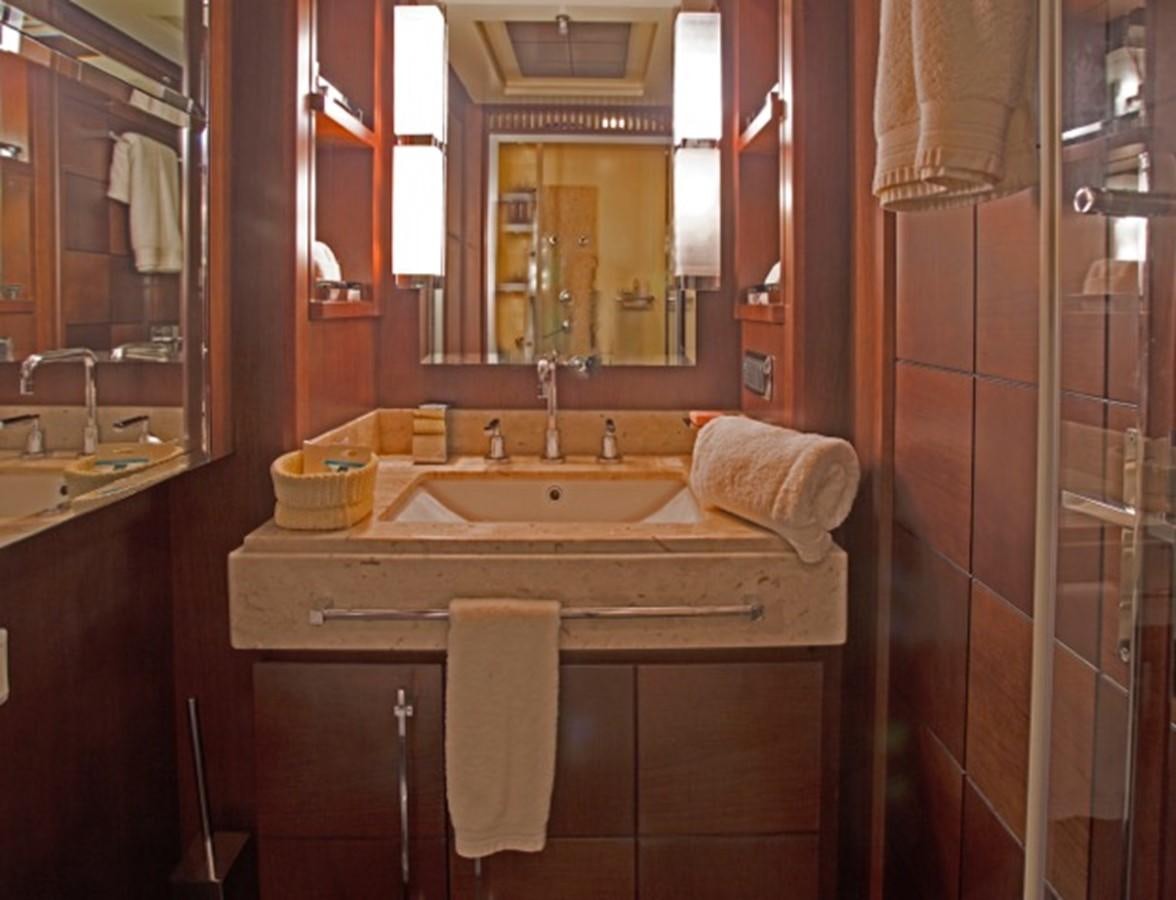 a bathroom with a sink and mirror aboard MOMENTO.   2006 AZIMUT 116 @ Yacht for Sale