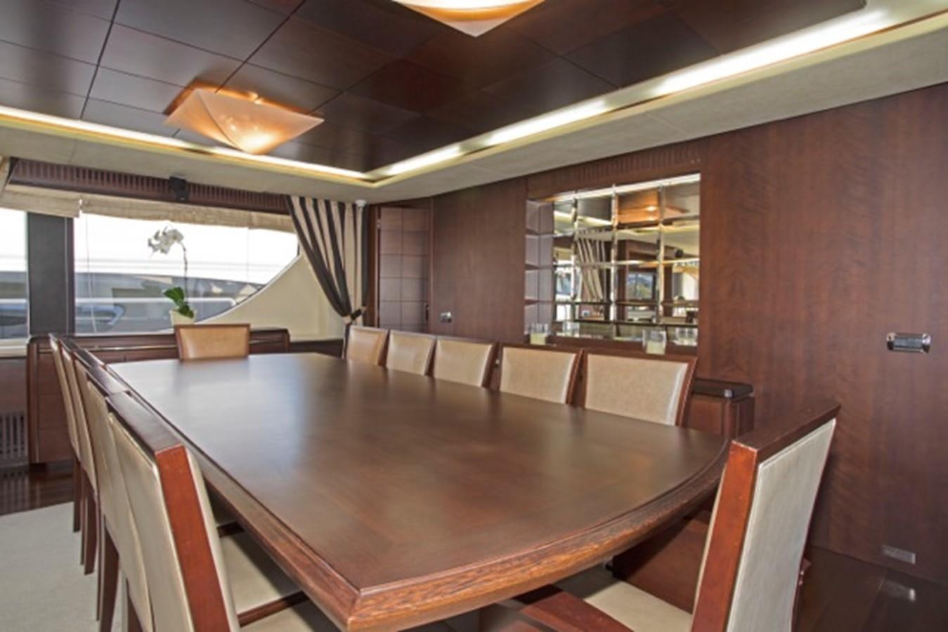 a large wooden table in a room aboard MOMENTO.   2006 AZIMUT 116 @ Yacht for Sale