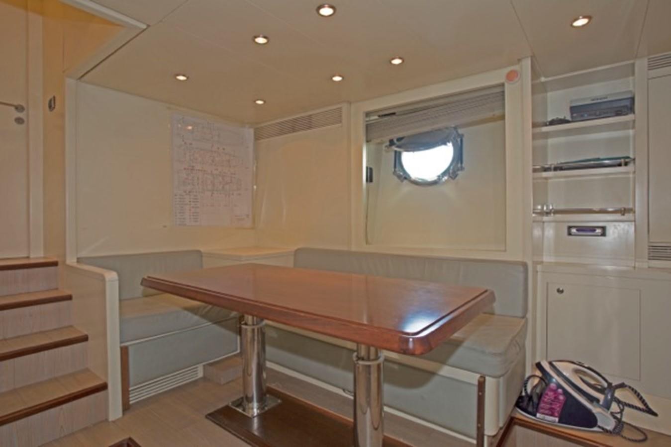 a room with a table and a window aboard MOMENTO.   2006 AZIMUT 116 @ Yacht for Sale