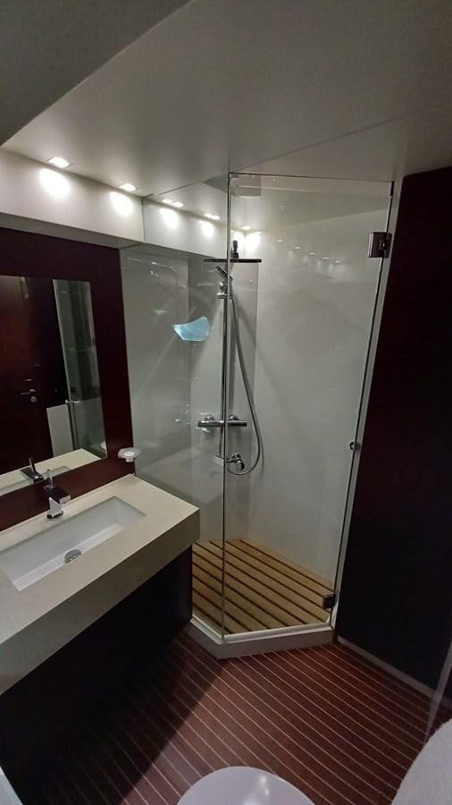 a bathroom with a glass shower aboard FREEDOM Yacht for Sale