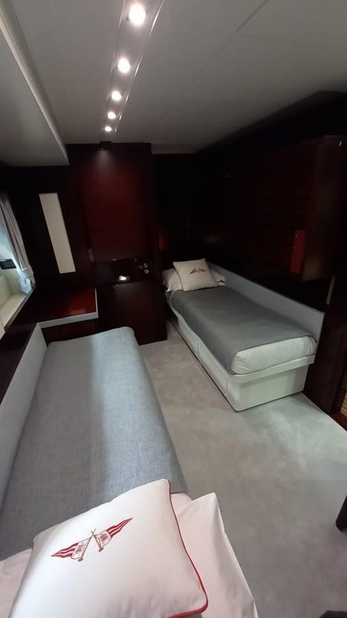 a room with a bed and a chair aboard FREEDOM Yacht for Sale