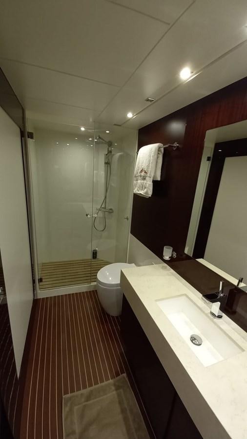 a bathroom with a shower and sink aboard FREEDOM Yacht for Sale