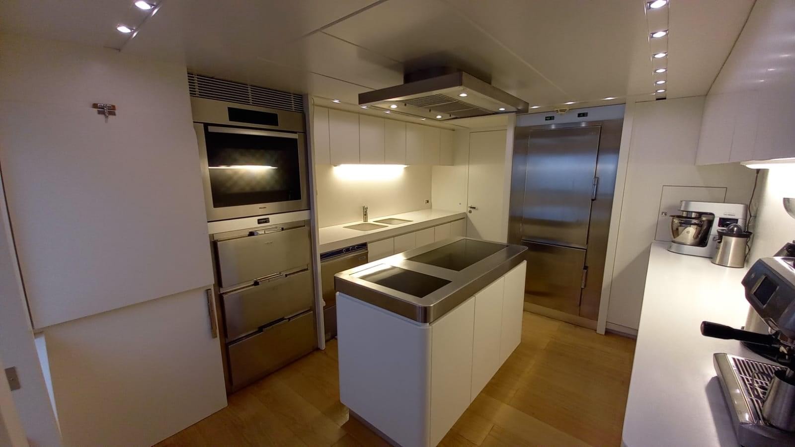 a kitchen with a large refrigerator aboard FREEDOM Yacht for Sale